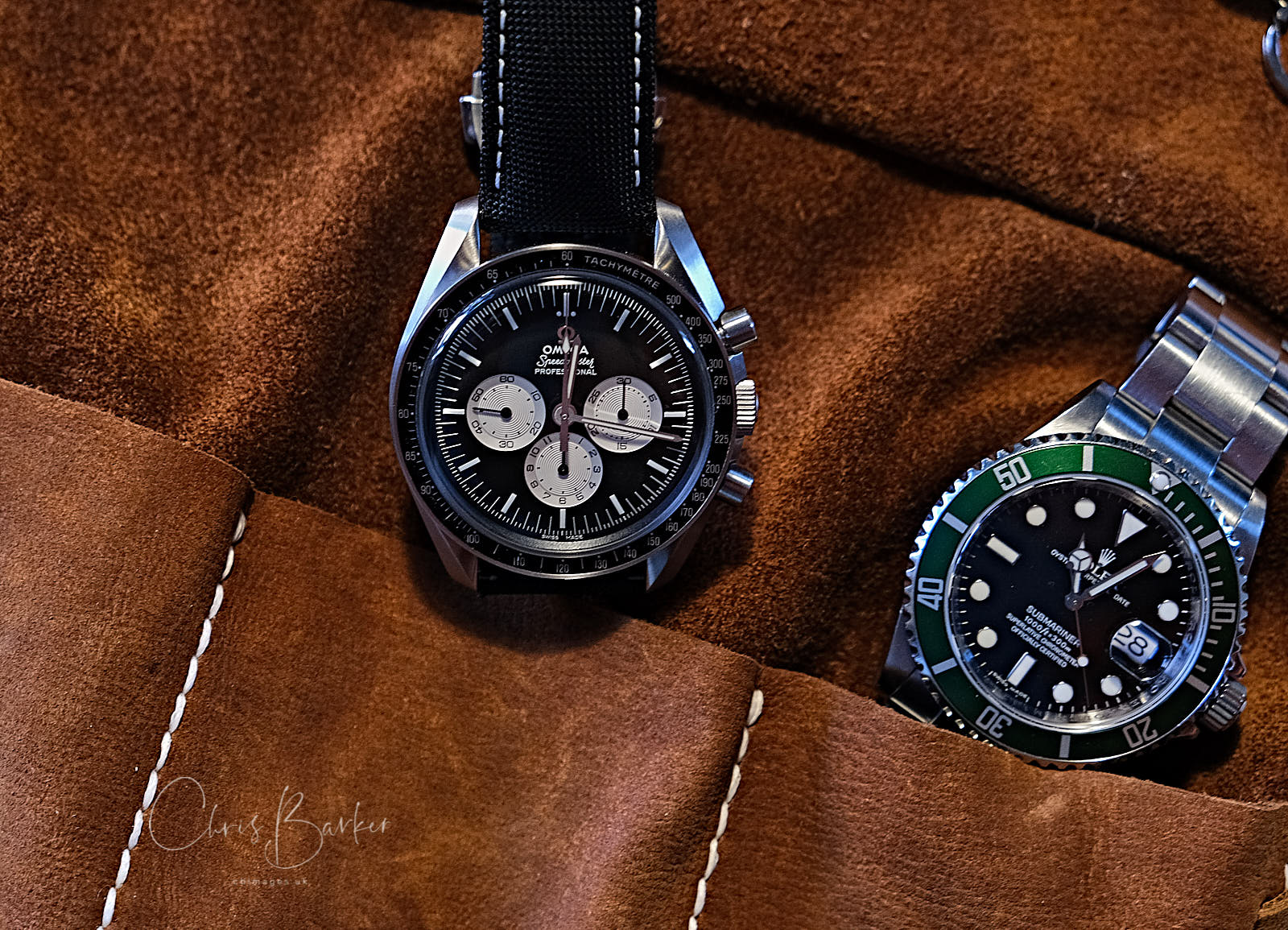 Two valuable watches close-up in a leather pouch.