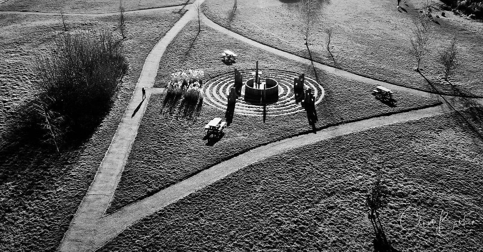 A monochrome photo of a girl and her shadow on the path of Millbridge Meadows in Gamlingay