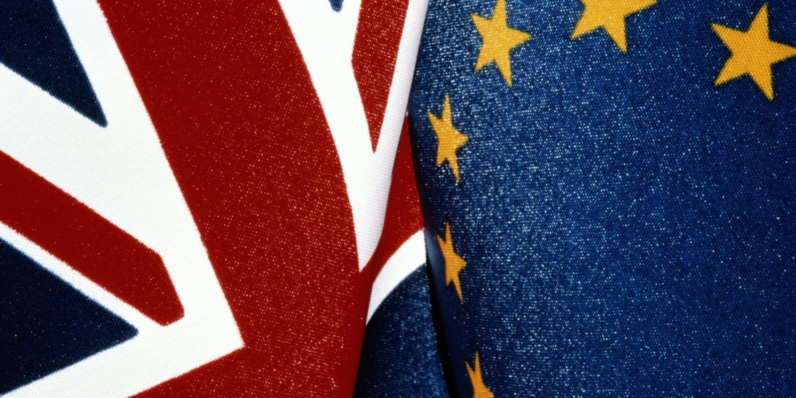 Close-up detail of Union Flag and EU flag against each other